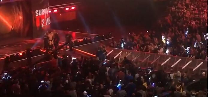 WWE officials breaking up a fight between Samoa Joe and Finn Balor